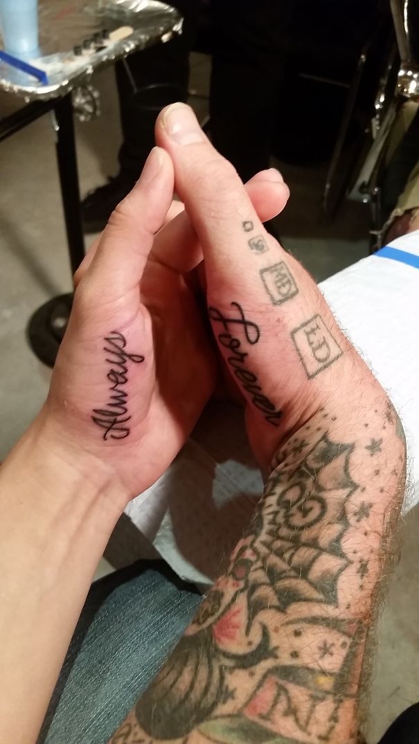 Couples' matching wedding tattoos on hands reading "Always" and "Forever."