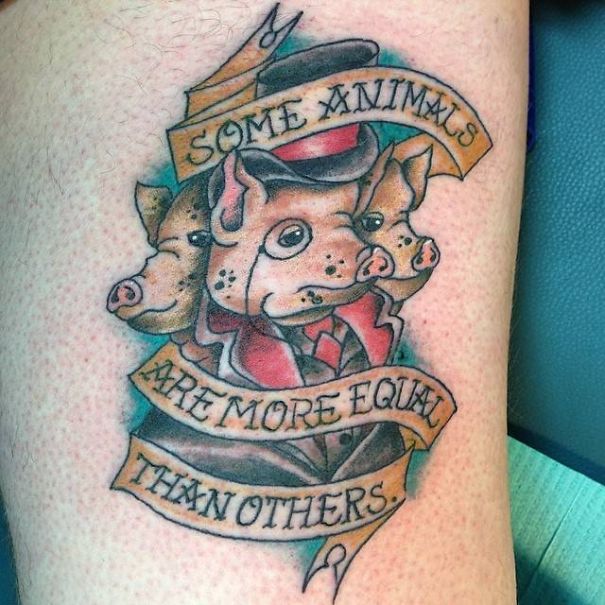 Book-inspired tattoo of pigs in suits with the text "Some animals are more equal than others."