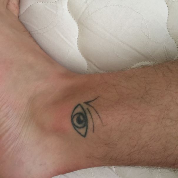 Ankle with an eye tattoo, inspired by a book illustration.