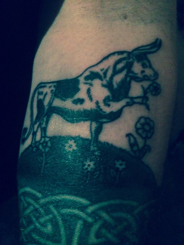 Tattoo of a bull holding a flower, inspired by a book, on a person's arm.
