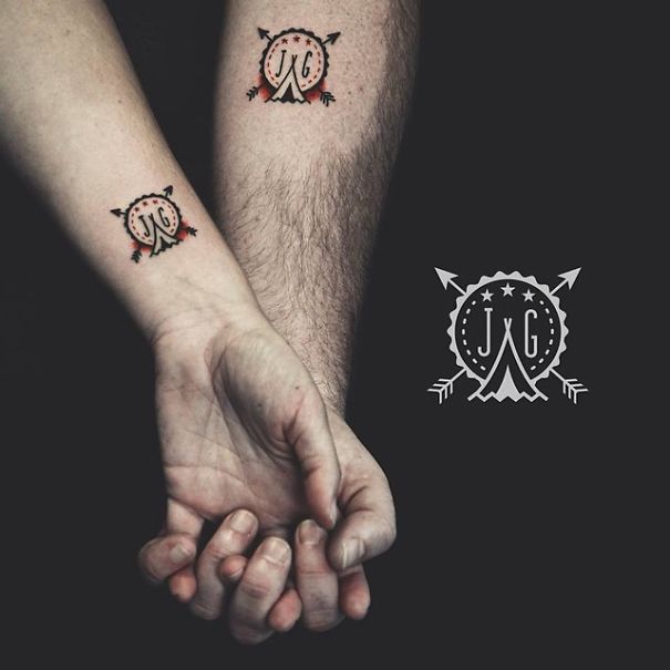 Matching wedding tattoos on couple's arms, showcasing unique designs as an alternative to rings.