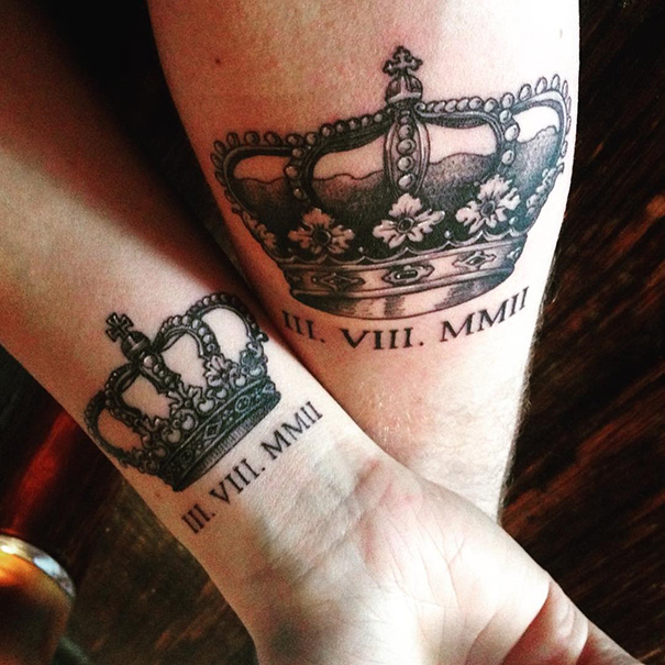 Matching couple wedding tattoos featuring crown designs with Roman numeral dates.
