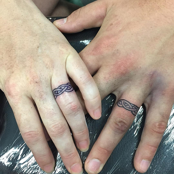 Matching wedding tattoos on couple's ring fingers, showcasing brave and unique commitment.