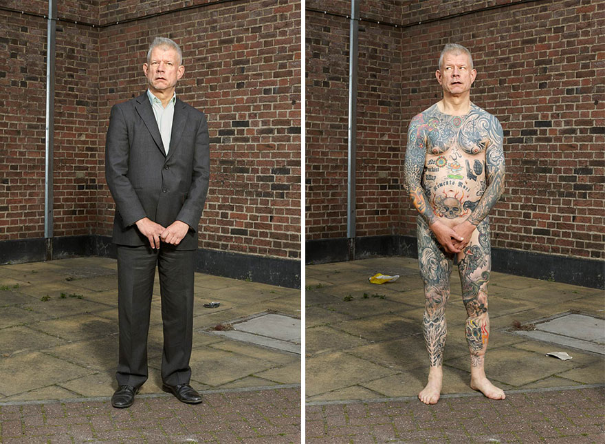 Man in a suit standing beside himself revealing full-body tattoos.