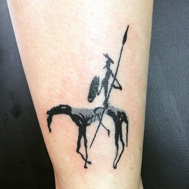 Book-inspired tattoo of a knight on horseback, ideal for bookworms.