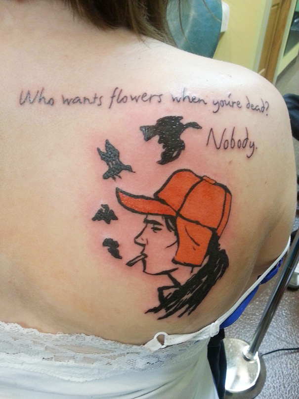 Tattoo of a character in an orange hat with birds, inspired by a book, on a person's back.