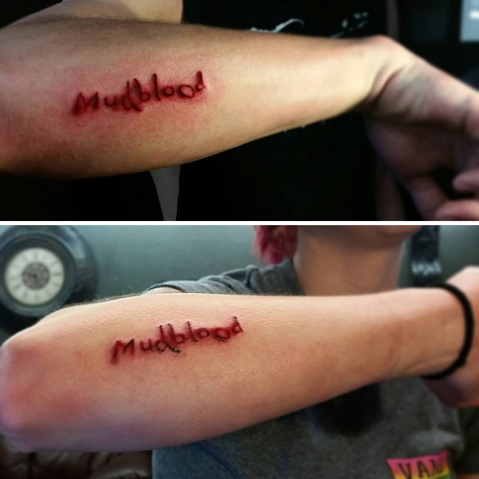 "Harry Potter tattoo of 'Mudblood' on forearm, resembling a scar. Unique design reflecting magical theme."