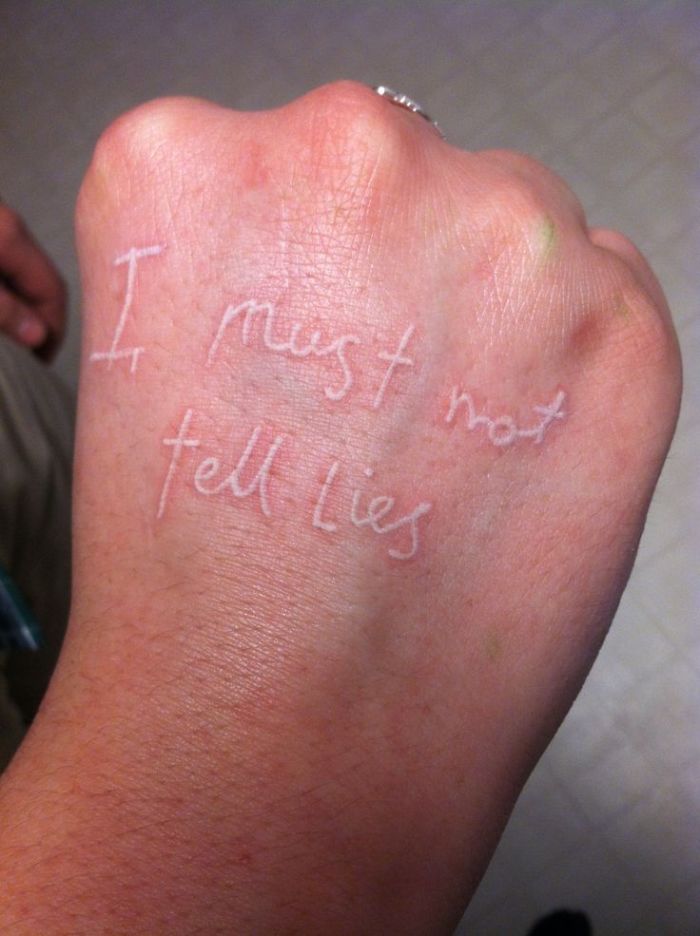 White ink Harry Potter tattoo on a hand reading "I must not tell lies."