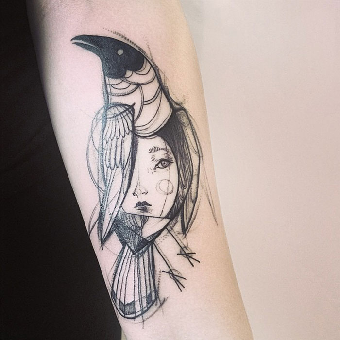 Sketch tattoo of a girl's face and bird, resembling a pencil drawing, inked on an arm.