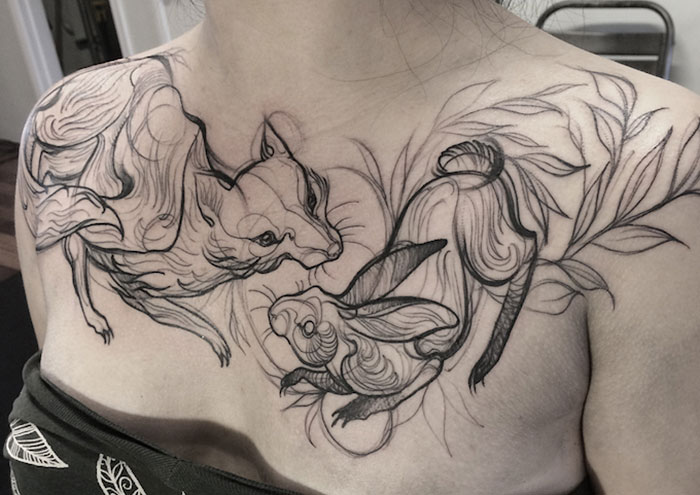Sketch tattoo of animal designs on shoulder, resembling pencil drawings by Nomi Chi.