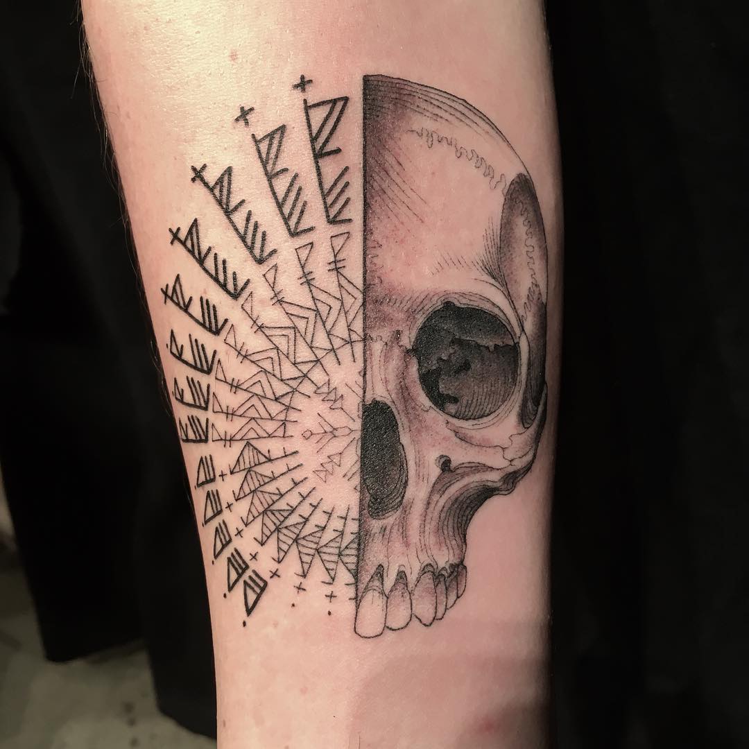 Tattoo of a half skull with geometric patterns, created by a famous artist offering free tattoos with a surprise element. Tattoo of a half skull with geometric patterns, created by a famous artist offering free tattoos with a surprise element.