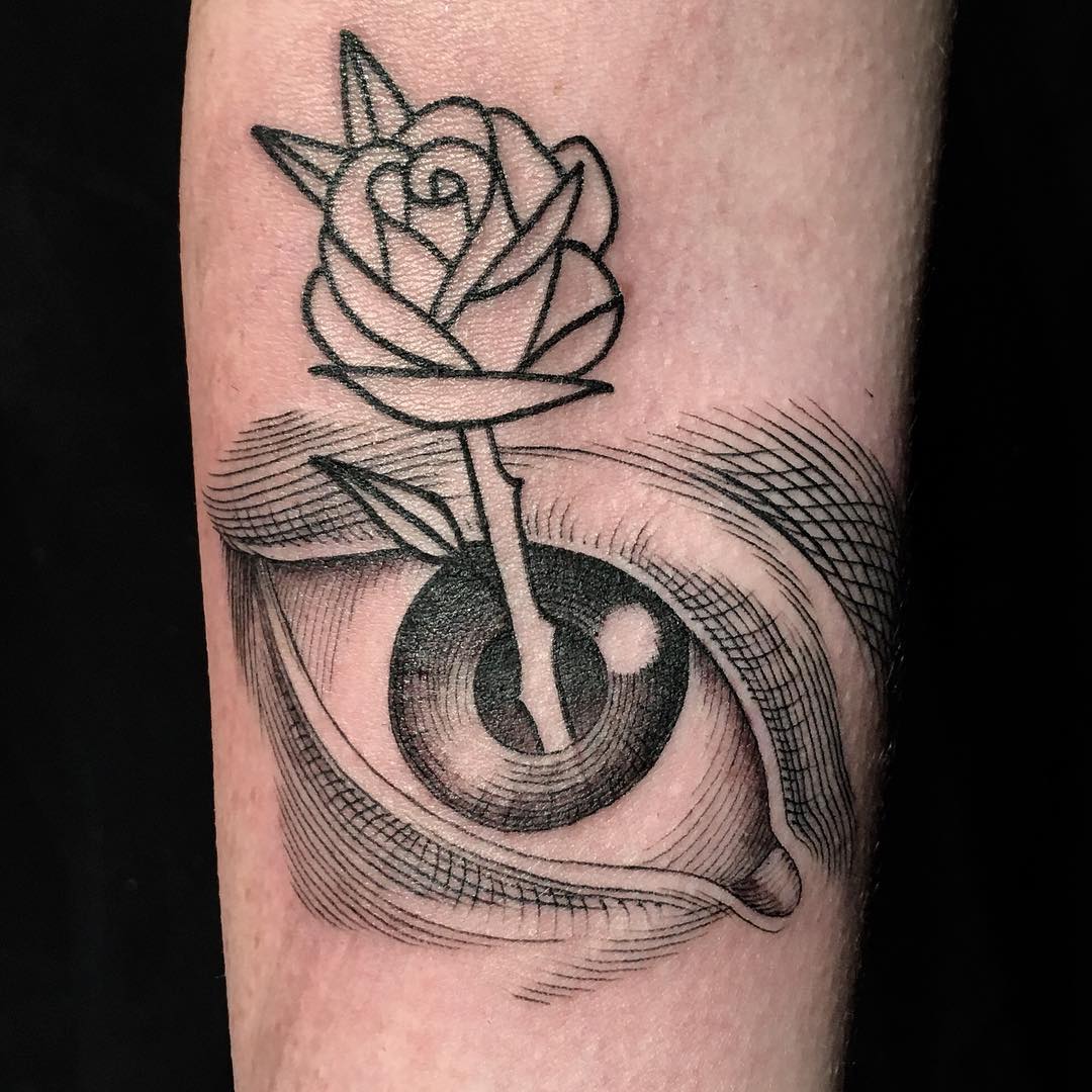 Creative tattoo of a rose emerging from an eye, designed by a famous tattoo artist. Creative tattoo of a rose emerging from an eye, designed by a famous tattoo artist.