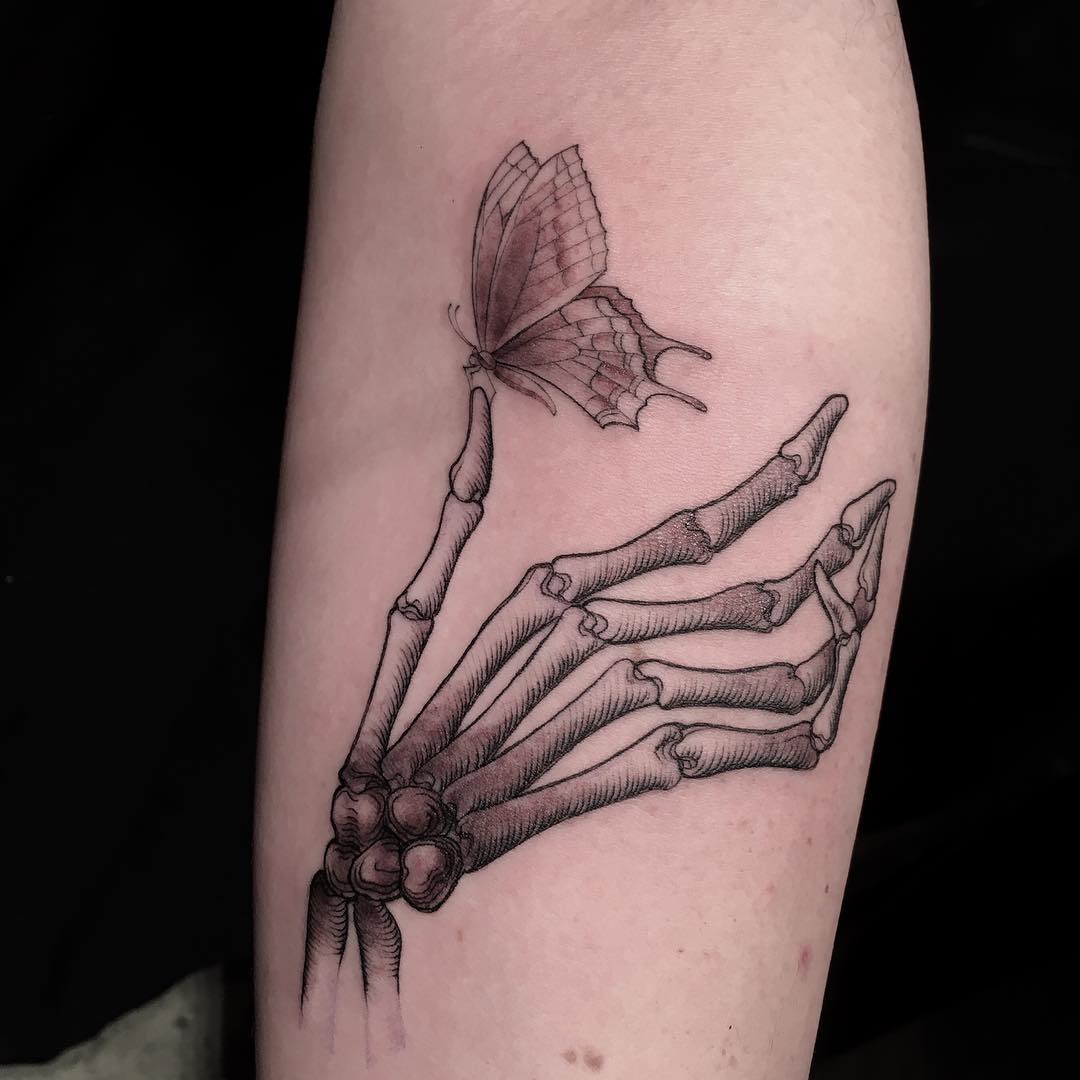 Tattoo of skeleton hand with butterfly by famous artist, done through surprise method. Tattoo of skeleton hand with butterfly by famous artist, done through surprise method.