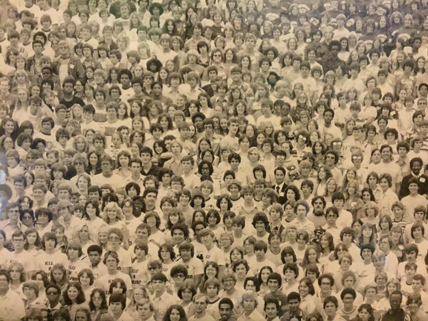 A large group of people closely packed together in a black and white photo, part of a "find the panda" puzzle.