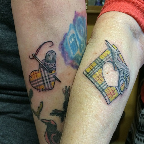 Mother-daughter tattoos of sewing tools on arms, symbolizing their bond.