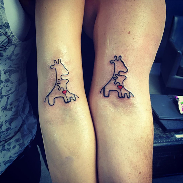 Mother-daughter tattoos of two giraffes with hearts, symbolizing their unbreakable bond.
