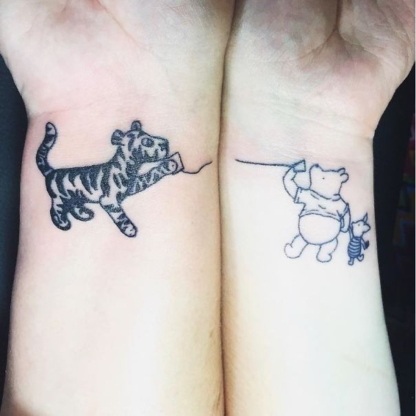 Mother-daughter tattoos featuring Tigger, Winnie the Pooh, and Piglet, symbolizing their unbreakable bond.