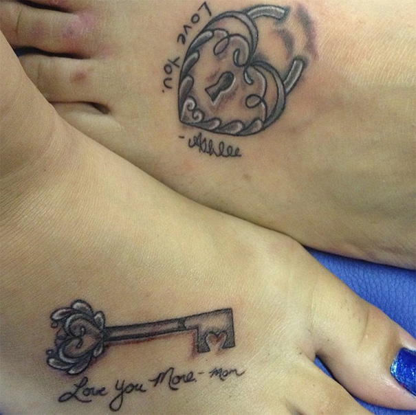 Mother-daughter tattoos with heart lock and key design symbolizing unbreakable bond.