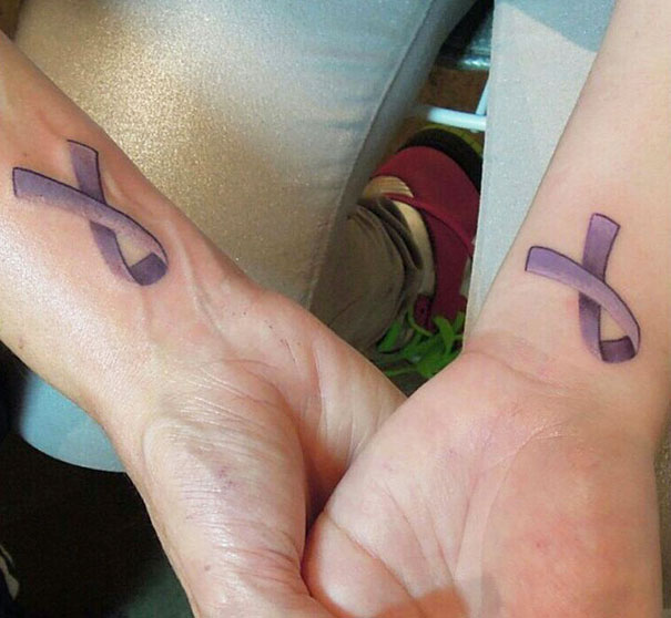 Matching purple ribbon tattoos symbolizing mother-daughter bond.