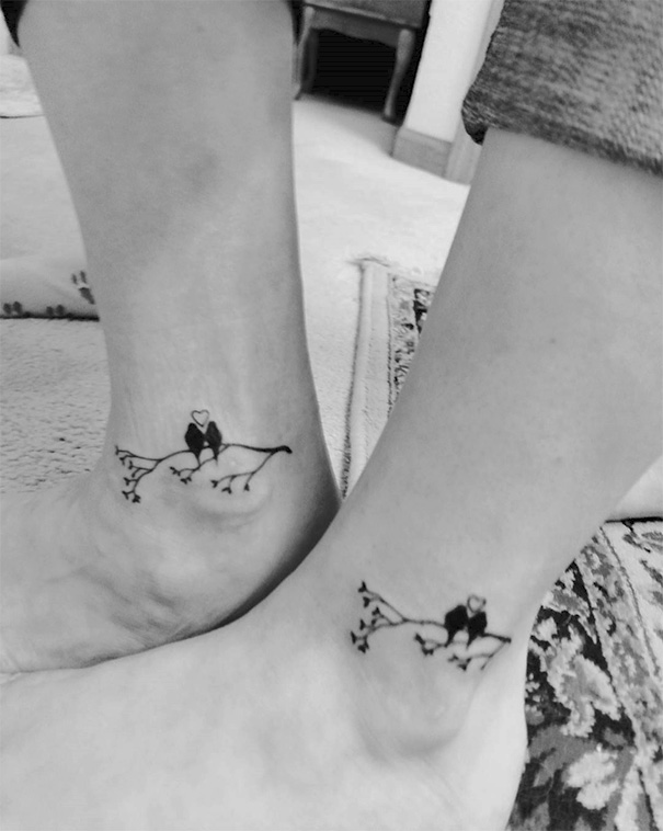 Mother-daughter tattoos on ankles featuring birds on a branch, symbolizing their bond.