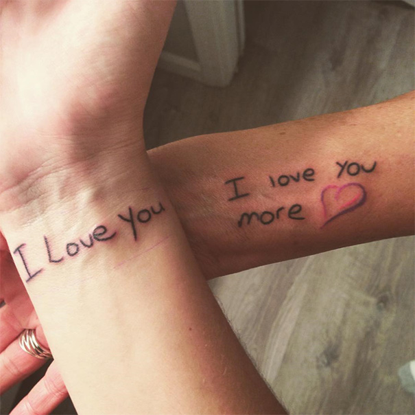 Mother-daughter tattoos with love notes on wrists, symbolizing their unbreakable bond.
