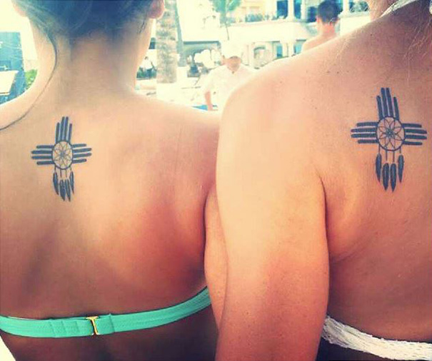 Mother-daughter tattoos on shoulders, showcasing their unbreakable bond with matching designs.