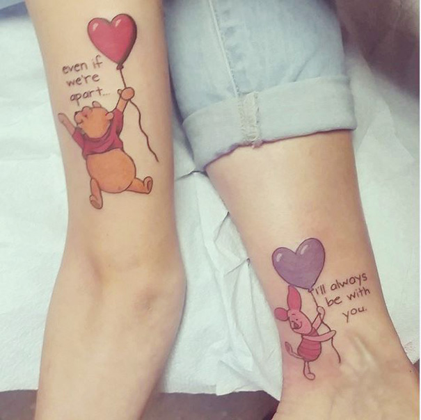 Mother-daughter tattoos of Pooh and Piglet with hearts, symbolizing unbreakable bond.