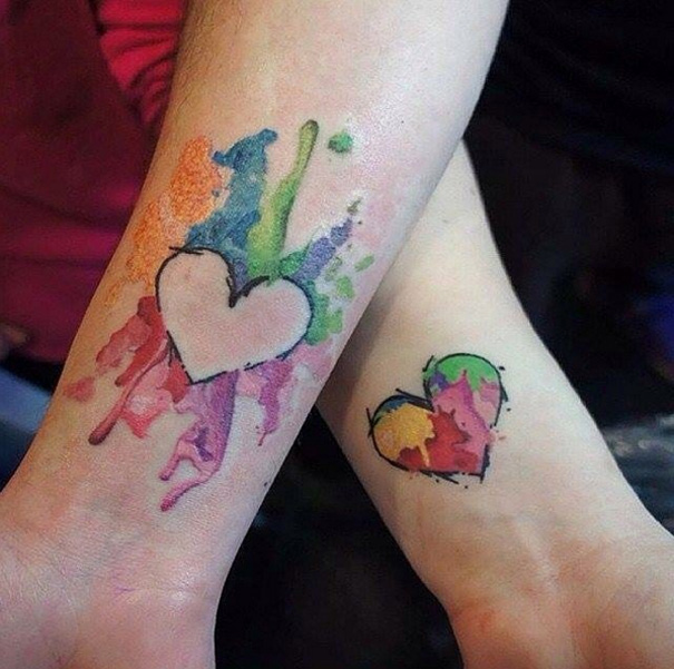 Colorful heart tattoos on arms, illustrating mother-daughter bond.