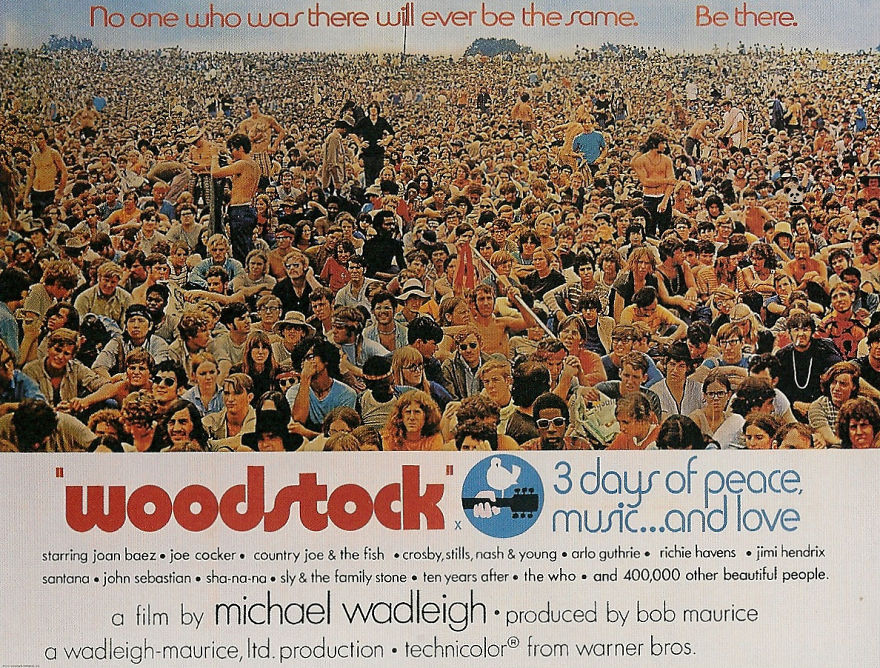 Woodstock crowd with banner, promoting 3 days of peace, music, and love.