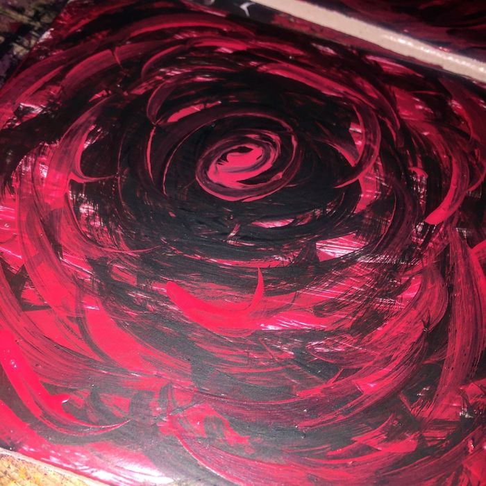 Abstract swirl painting with bold red and black colors, evoking a striking celebrity doppelganger animals theme.