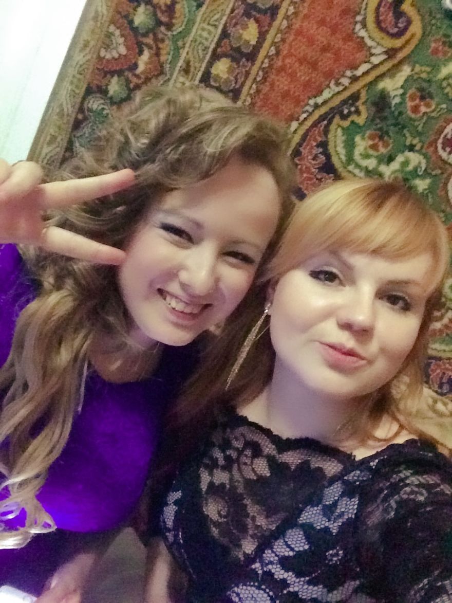 Two smiling women posing for a photo, showcasing the beauty in diversity.