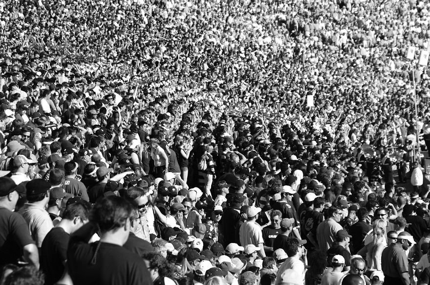 Crowd challenge puzzle image to find the panda among a large group of people, monochrome setting.