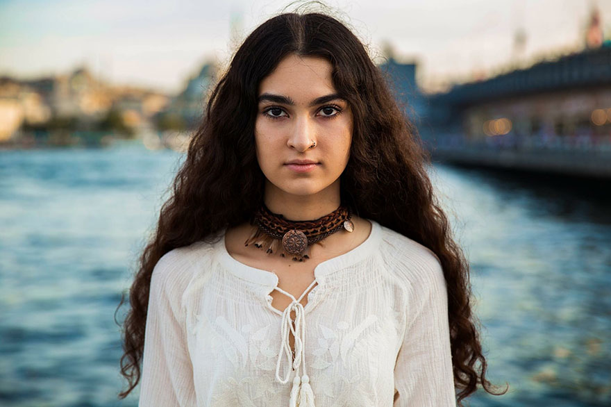 Woman photographed by Romanian photographer, showcasing cultural beauty by the water.
