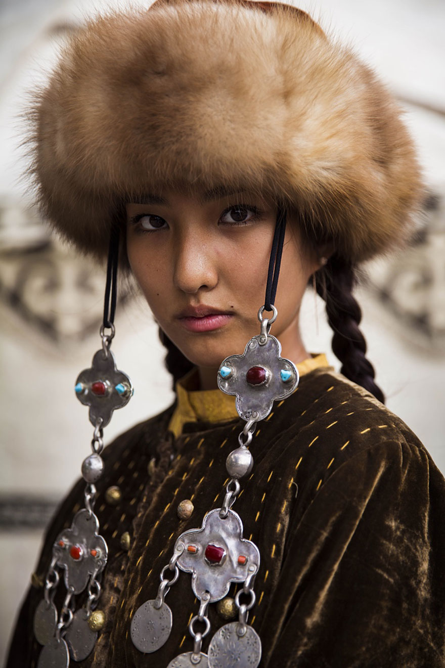 Woman in traditional attire with fur hat, photographed by Romanian photographer, showcasing diverse beauty worldwide.