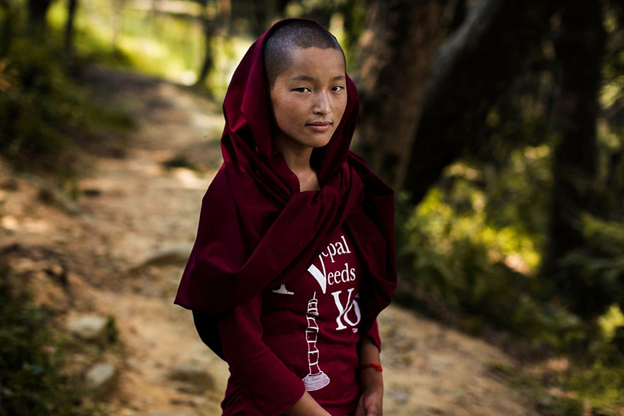 Young woman in a red shawl, photographed by Romanian photographer, showcases diverse beauty in nature.