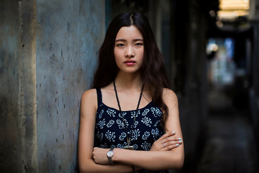 Portrait of a woman in a patterned dress, showcasing diverse beauty, photographed by a Romanian photographer.
