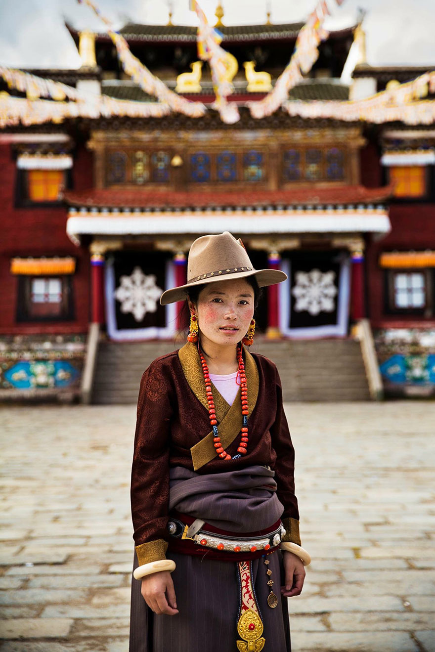 Romanian photographer captures woman in traditional attire, showcasing global beauty against a temple backdrop.