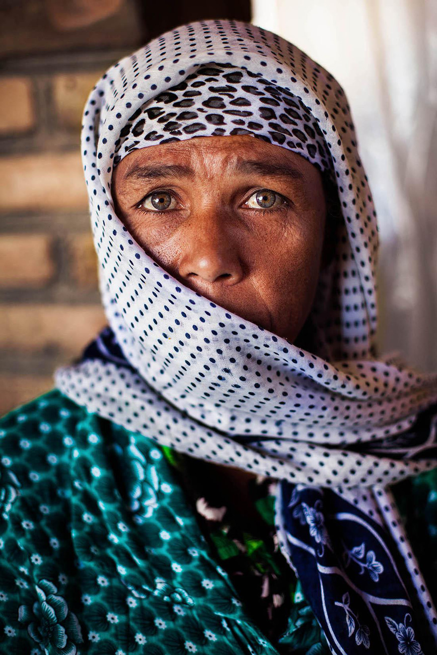 Woman in patterned scarf, photographed by Romanian photographer, showcasing global beauty.