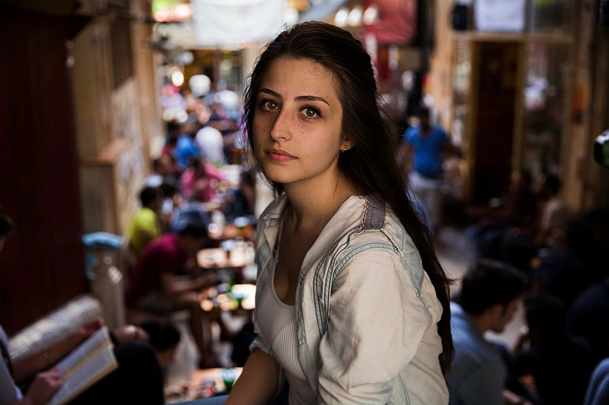Romanian photographer captures a woman in a bustling street scene, showcasing diverse beauty worldwide.