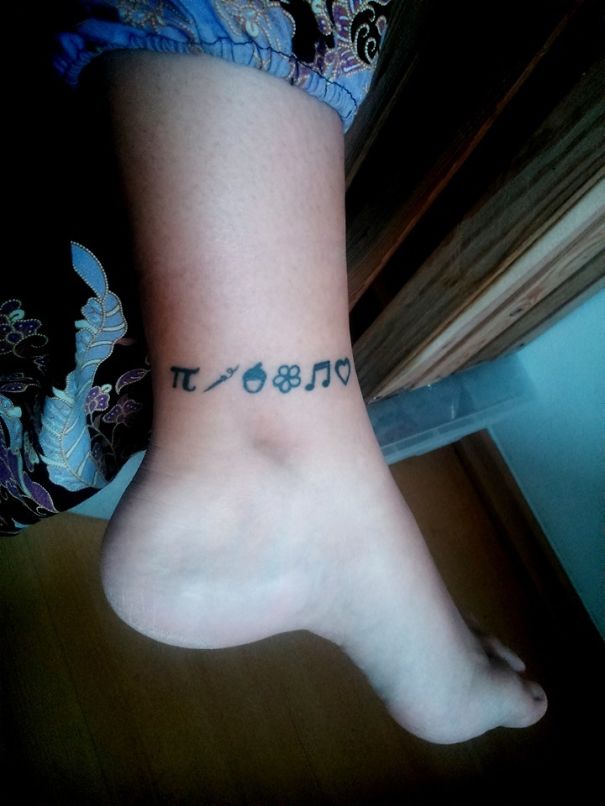 Minimalist tattoos on leg featuring small symbols including pi, arrow, acorn, flower, music note, and heart.