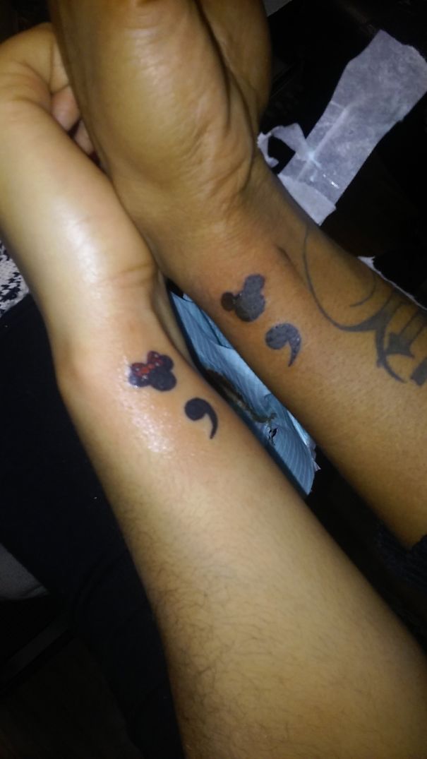 Minimalist semicolon tattoos on forearms with small Mickey Mouse symbol.