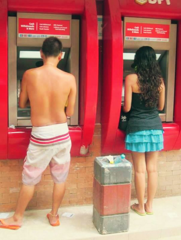 Couple Withdrawing Cash From Atm In The Philippines