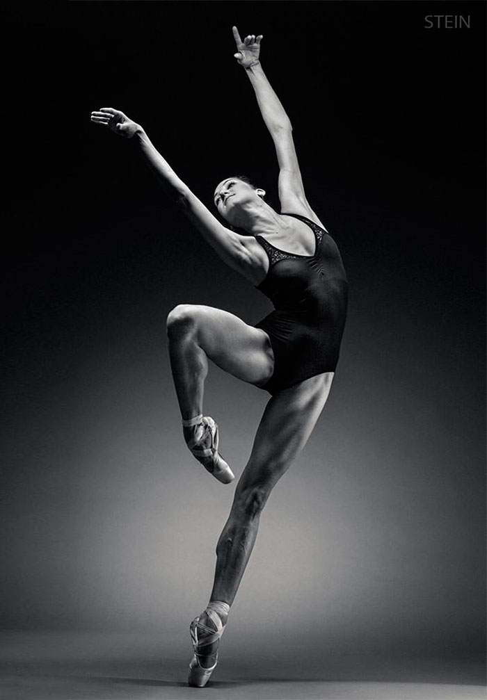 Ballet dancer in a graceful pose, showcasing the artistry and strength of ballet performance.