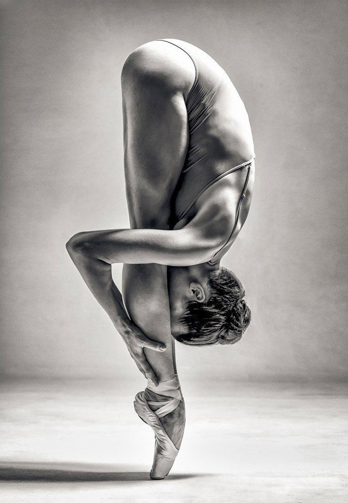 Ballet dancer in a dramatic pose, showcasing balance and flexibility, emphasizes the cost of applause in ballet.