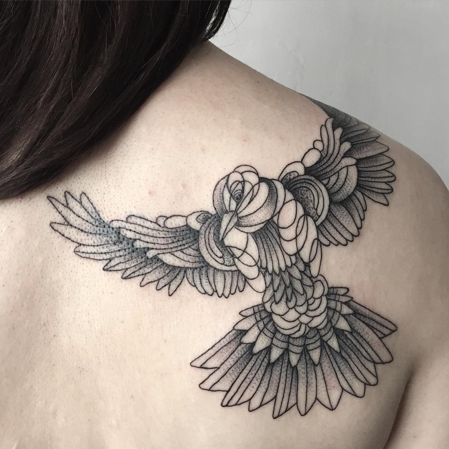Tattoo of an abstract bird design on a person's back by Russian artist, featuring intricate dark and eerie creature elements.
