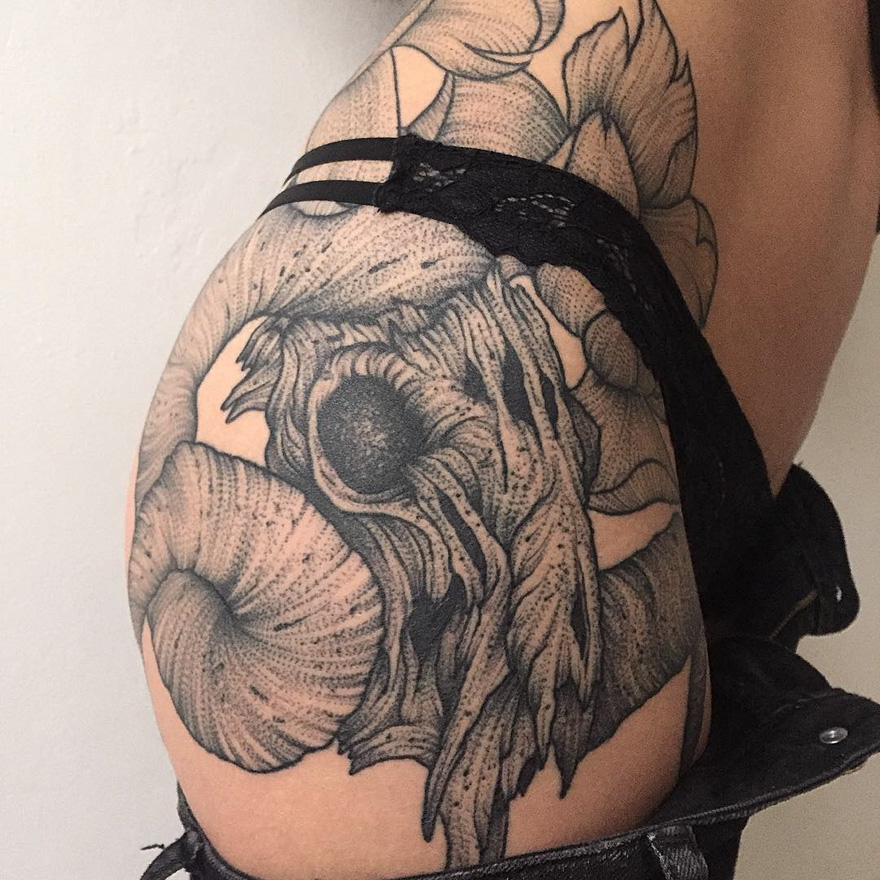 Dark and eerie creature tattoo on arm showcasing intricate design by a Russian artist.