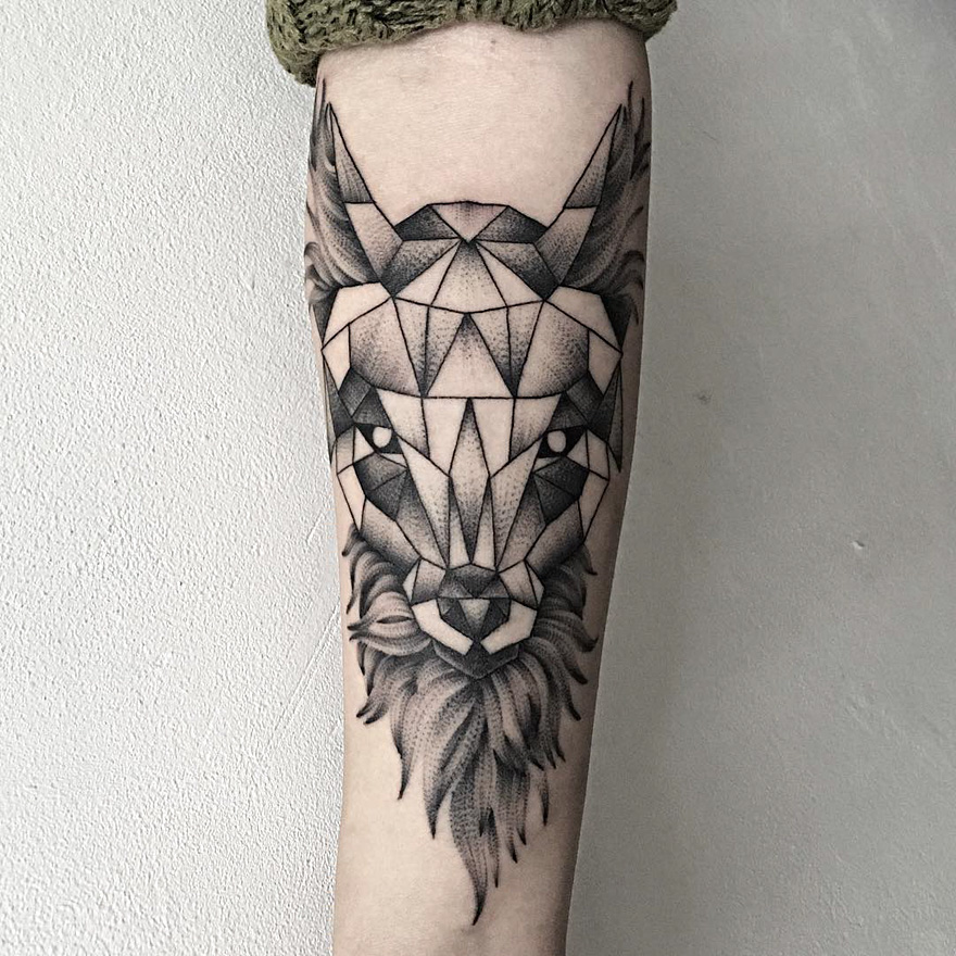 Geometric creature tattoo on forearm by Russian artist, showcasing dark and eerie design elements.