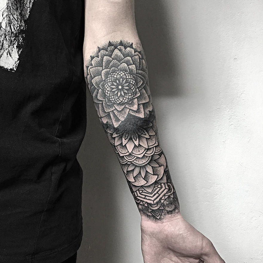 Arm with intricate creature tattoo by a Russian artist, displaying dark and eerie floral patterns.