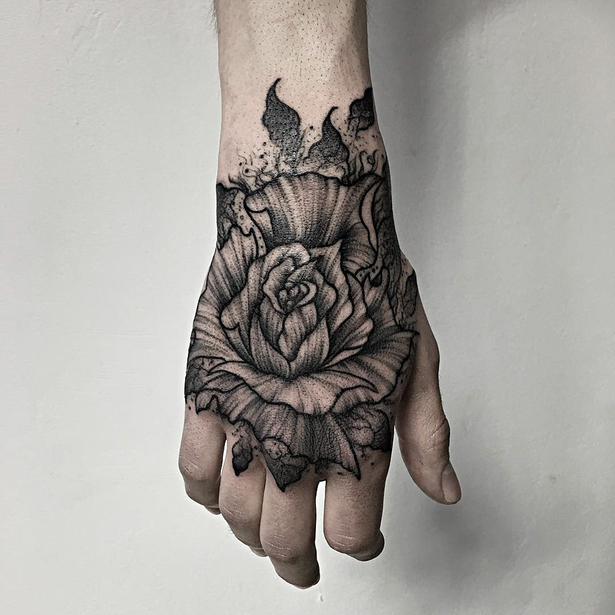 Dark and eerie hand tattoo by Russian artist featuring a detailed rose design.