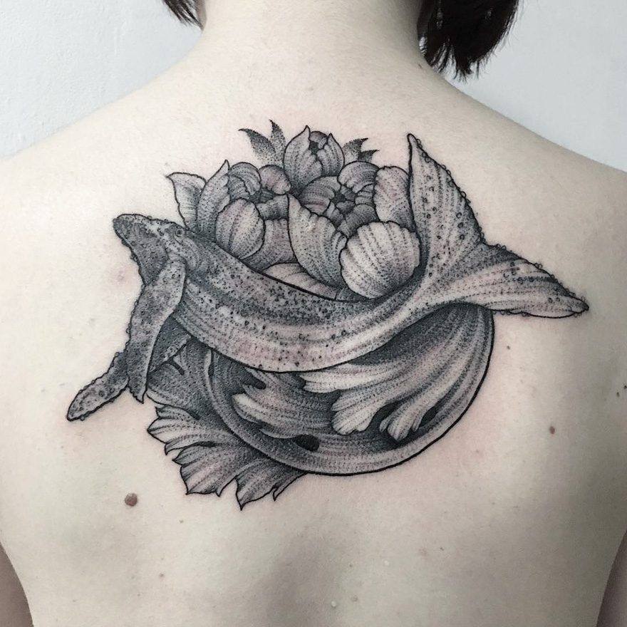 Tattoo of a mythical creature with flowers on a person's back, created by a Russian artist.